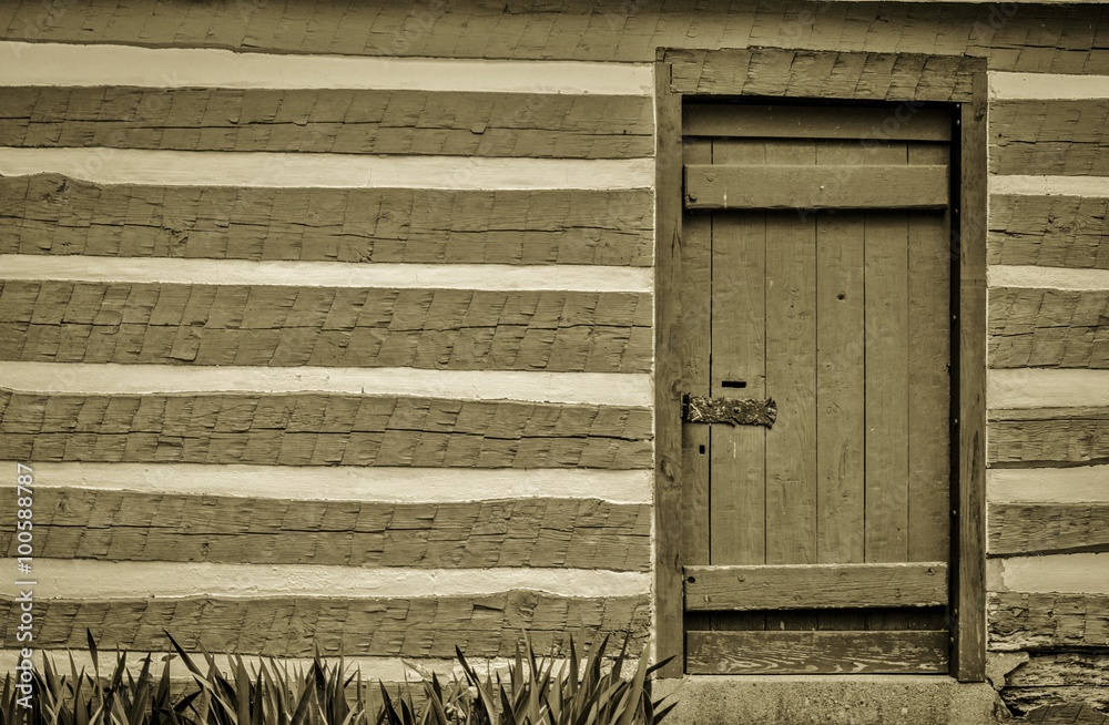 Pioneer Log Cabin. Front door and exterior wall of a pioneer log cabin