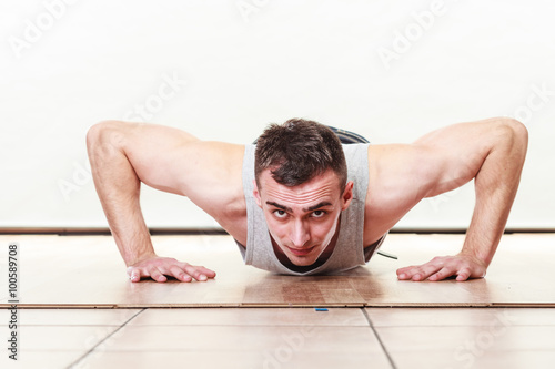Obraz na plátně Sports man making pushups,