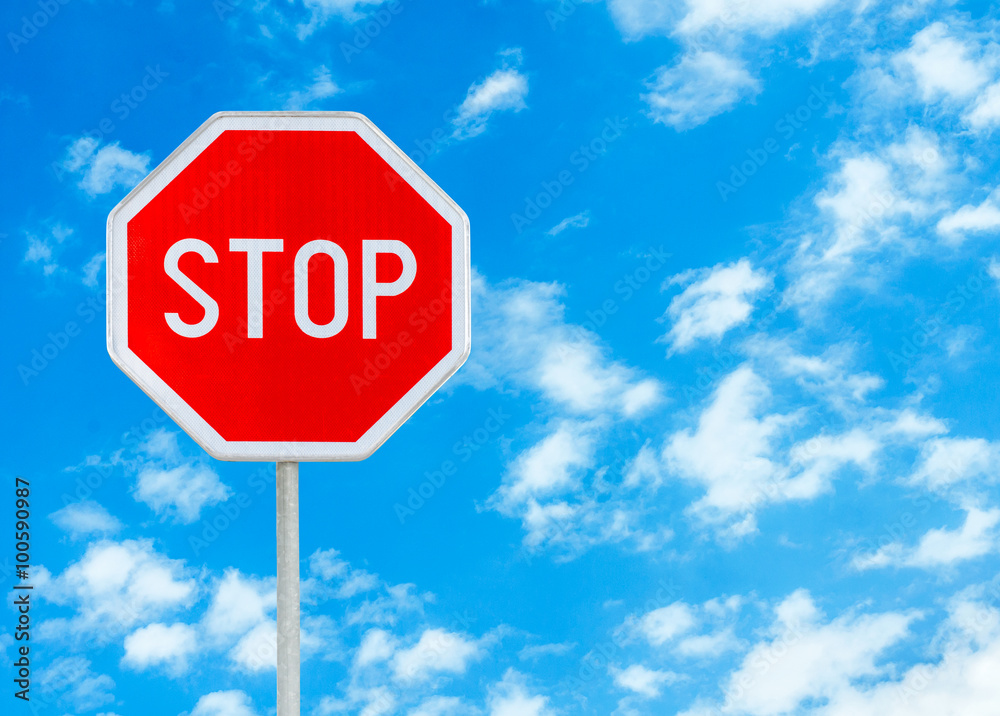 Stop sign against blue sky background