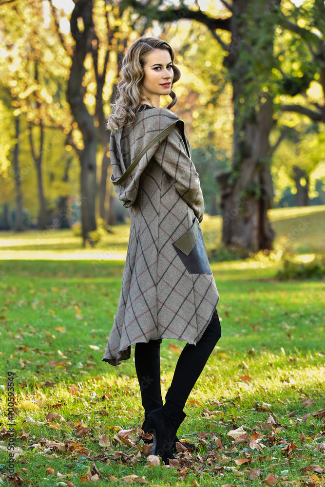 Fashion outdoor photo of gorgeous young woman with beautiful make-up and hairstyle posing in autumn park. Fashion outdoor photo of gorgeous young woman with beautiful make-up and hairstyle posing in autumn park.