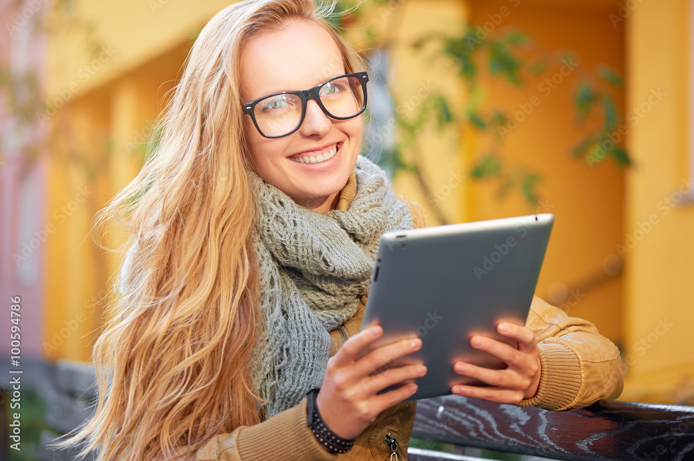 Young woman sitting on the bench with tablet Young woman sitting on the bench with tablet