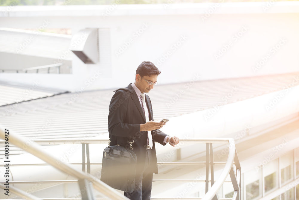 indian business male on a phone conversation outdoor