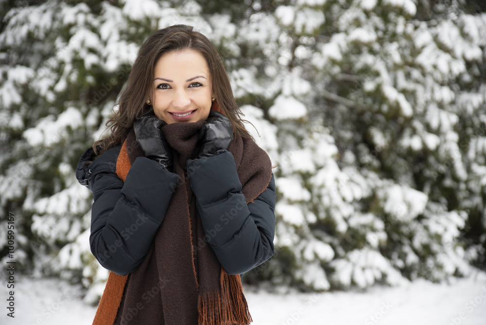 Portrait of smiling young woman in winter park. Portrait of smiling young woman in winter park.