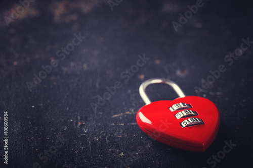  Padlock on the dark shape of a heart,the symbol of love.The background to the romantic holiday of Valentine's day.Toned image.Copy space.selective focus.