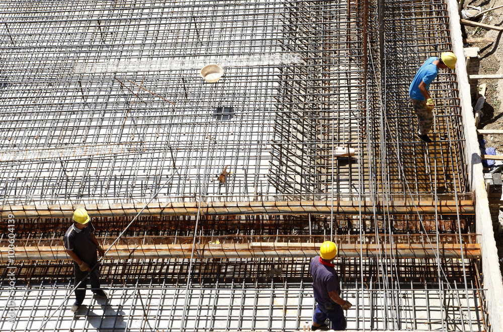 worker in the construction site making reinforcement metal frame