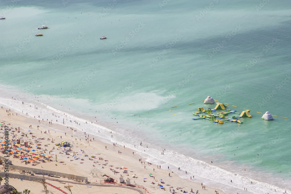 Fototapeta premium background landscape beach in Dubai Marina with holiday travelers and waves on the Gulf