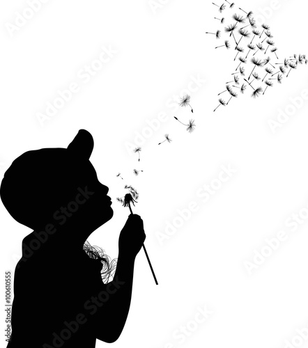 child blowing on black dandelion