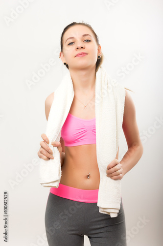 Young athletic girl finished training, holding a bath towel