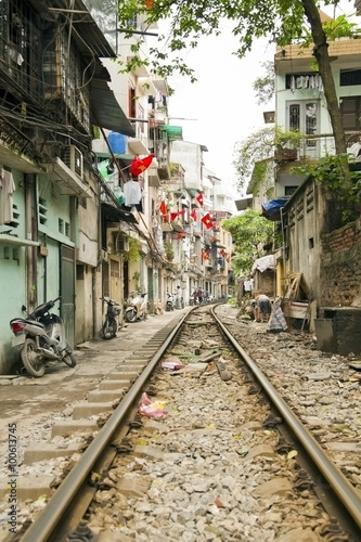 train passing through streets of hanoi slums, vietnam