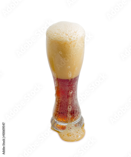 Beer glass with dark beer and head of foam