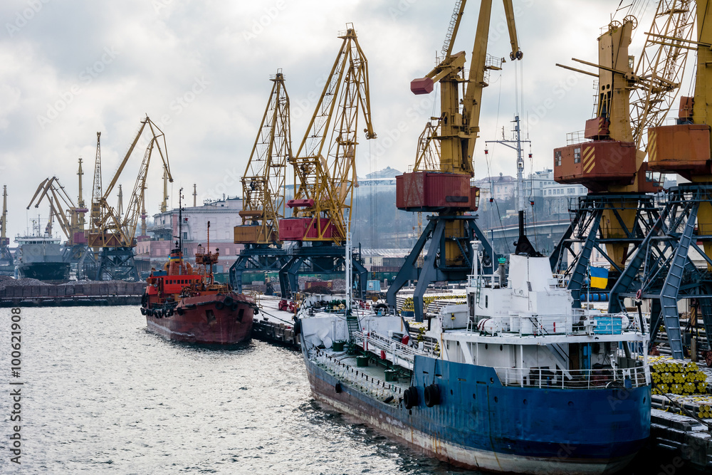 сargo cranes in the port in the winter and boats