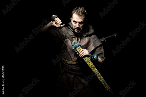 Viking warrior with sword over black background going to war