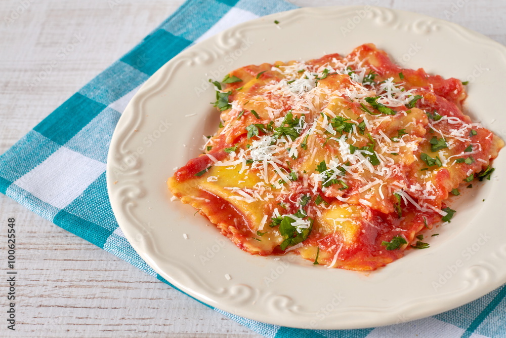 Ravioli with tomato sauce and parmesan cheese Ravioli with tomato sauce and parmesan cheese