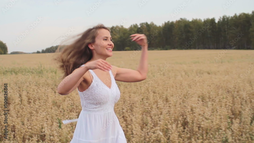 Beautiful smiling girl running towards her boyfriend through the field of rye, he lifting her up and kissing Beautiful smiling girl running towards her boyfriend through the field of rye, he lifting her up and kissing