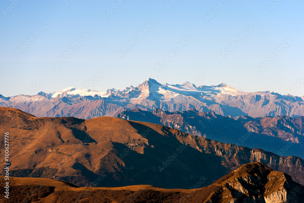 Italian alps in Veneto and Trentino. In the foreground the Monte Baldo (Baldo Mountain) and in the background the group of Adamello seen from the plateau of lessinia