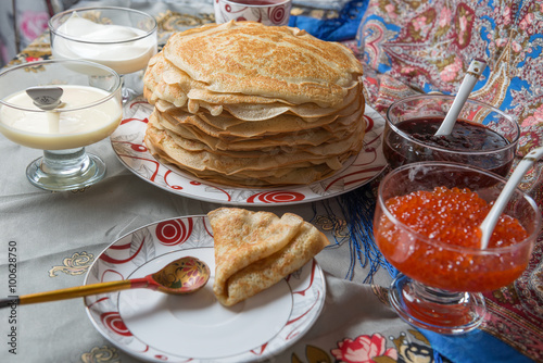 Pancakes with red caviar, jam, cream and tea during Shrovetide photo