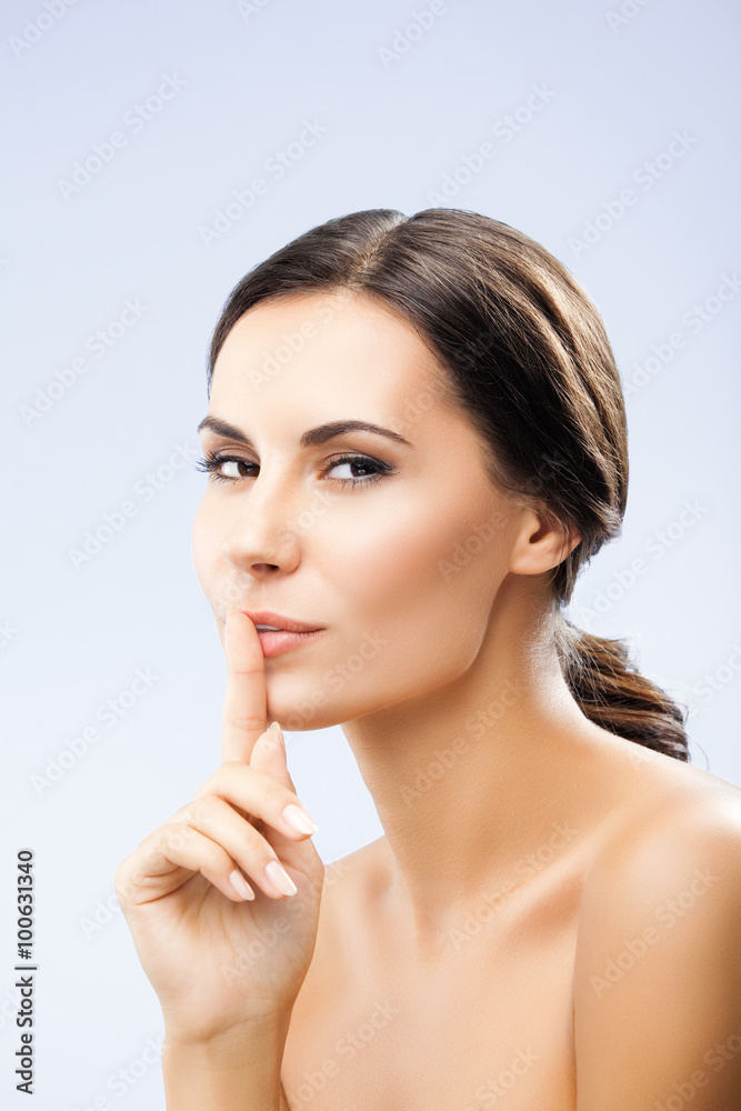Woman keeping finger on her lips Woman keeping finger on her lips