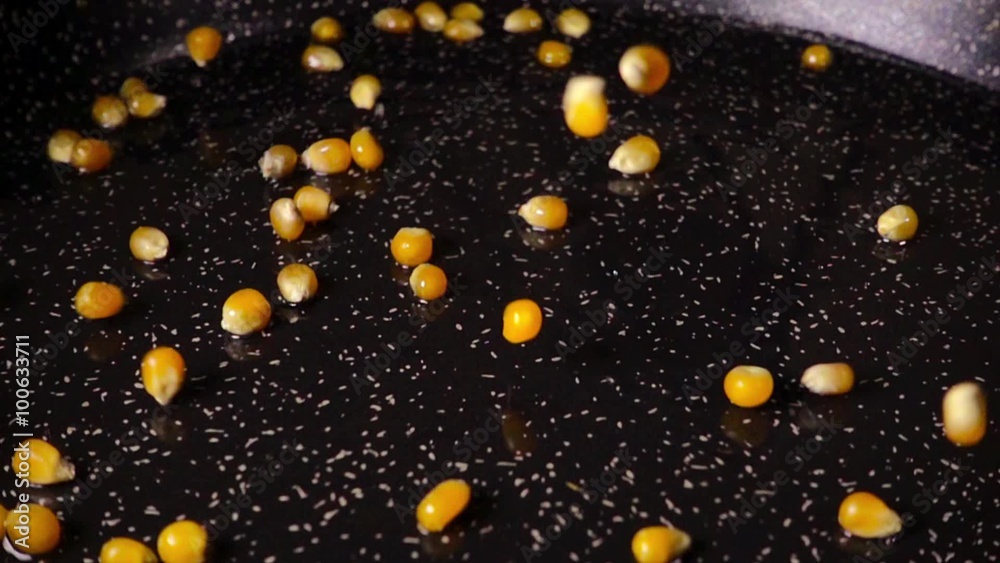 Popcorn is poured into the pan, slow motion Popcorn is poured into the pan, slow motion