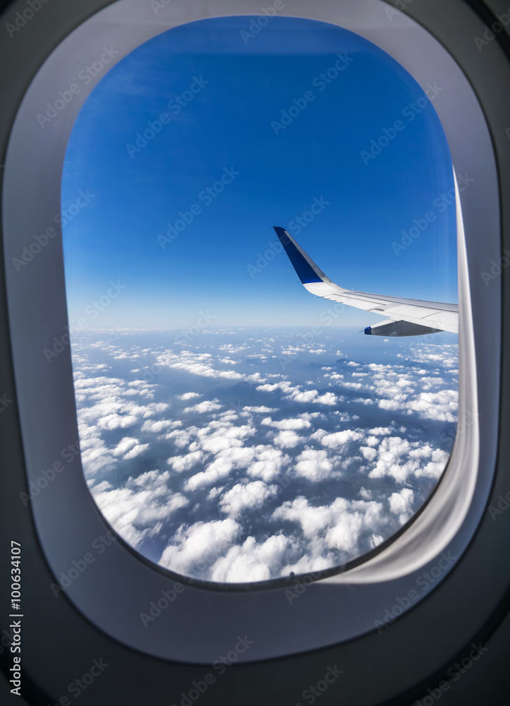 View through the window of a passenger plane flying above beauti