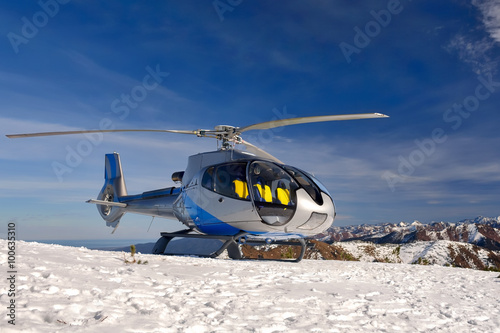 Helicopter landed on mountain Mamay near lake Baikal. View of the mountain range Khamar-Daban.