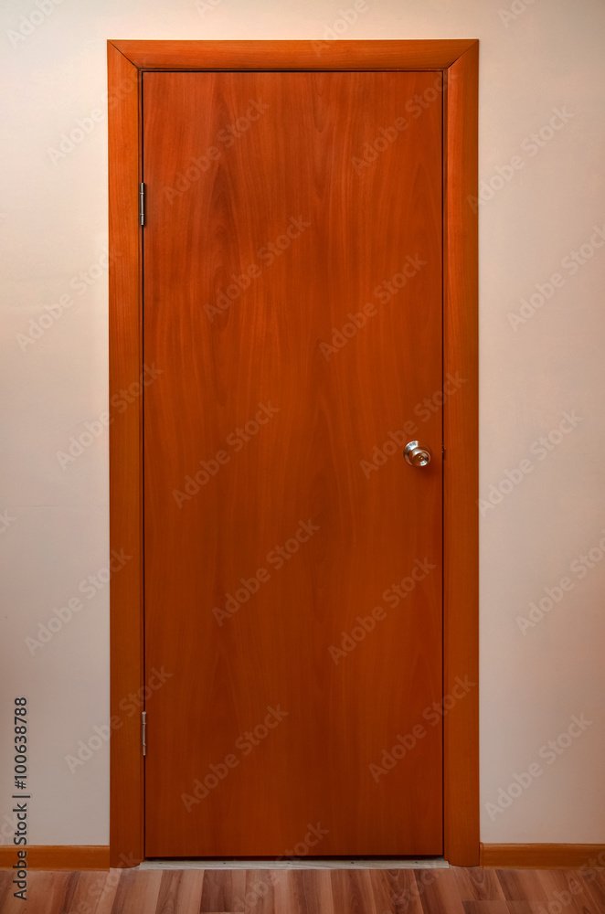 wooden door with metal pen on a blank wall wooden door with metal pen on a blank wall