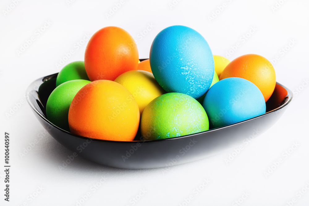 Easter eggs in a black ceramic plate. Shallow depth of field. Selective focus. Easter eggs in a black ceramic plate. Shallow depth of field. Selective focus.