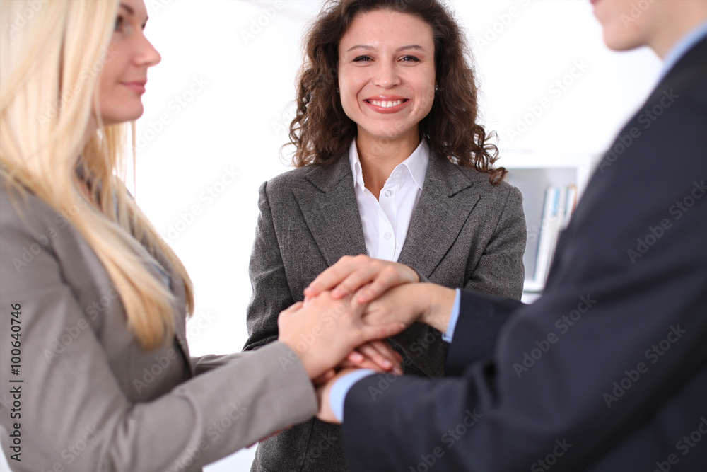business people group joining hands and representing concept of friendship and teamwork