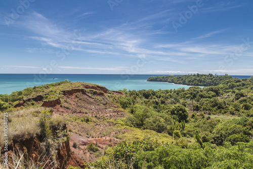 Red rocks on green jungles and turquoise water on a colorful landscape in Madagascar, Africa.