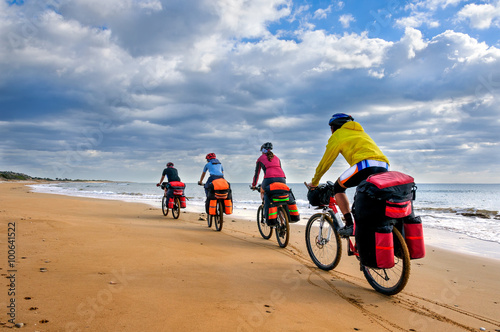 group of cyclists riding sandy beach bike
