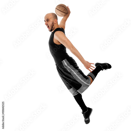 Basketballer makes a slam dunk on white background
