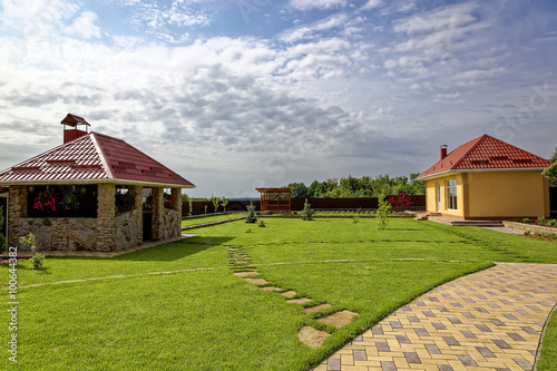 Green lawn and buildings in the backyard
