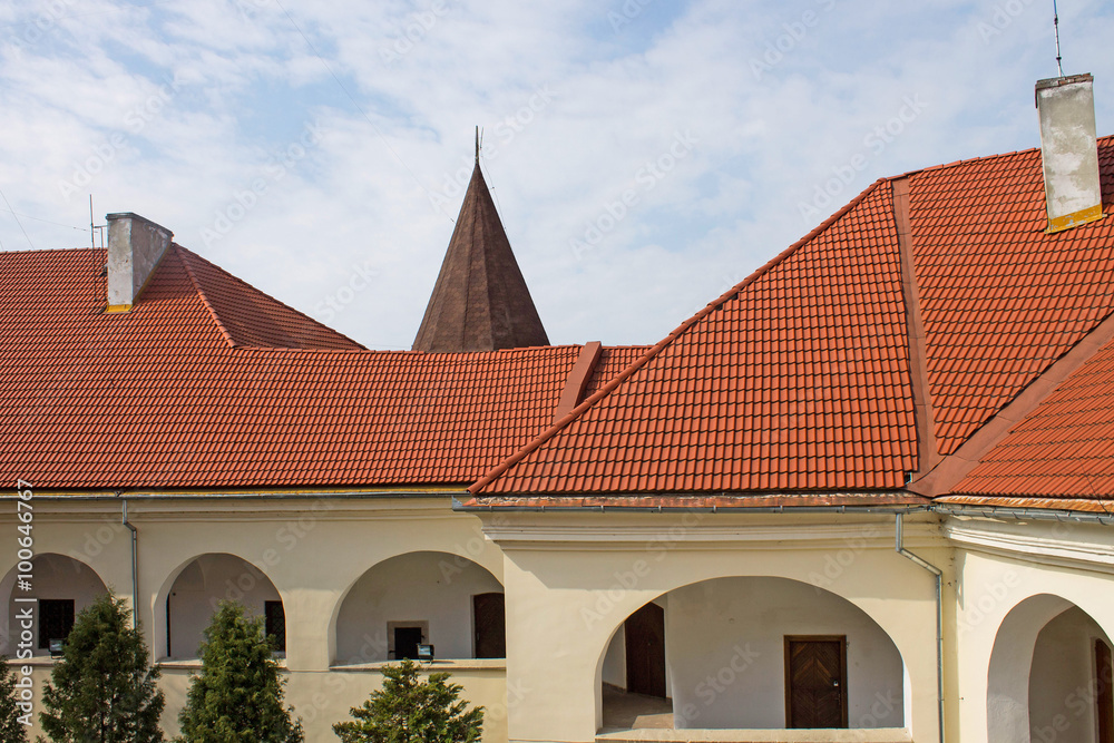 Building with the red roof and large windows