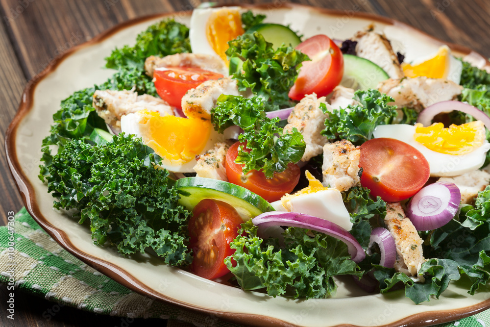 Fresh salad with chicken, tomatoes, eggs and lettuce on plate Fresh salad with chicken, tomatoes, eggs and lettuce on plate