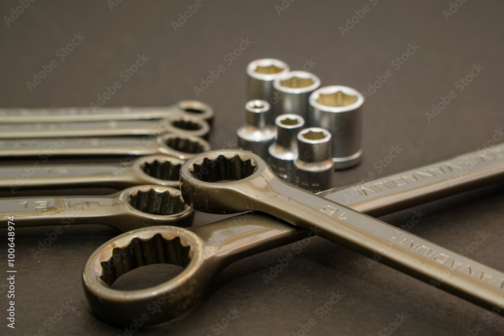 wrench, working wrench, wrench metal, set of wrenches, repair, tools, work on a gray Textured Background, and build in composition wrench, working wrench, wrench metal, set of wrenches, repair, tools, work on a gray Textured Background, and build in composition