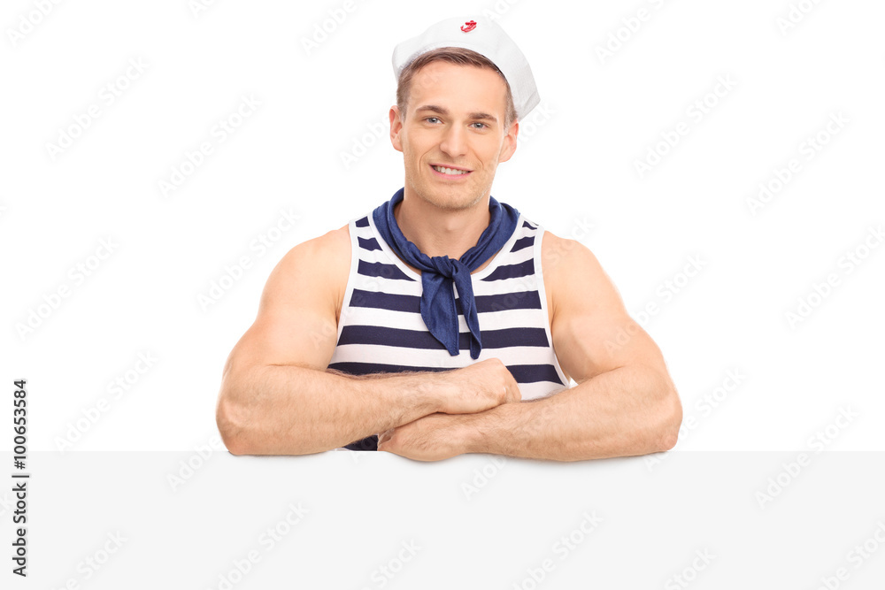 Muscular sailor standing behind a signboard Muscular sailor standing behind a signboard
