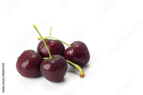 a small group of cherries arranged in a white background