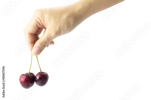 hand holding the two fresh cherries on white background