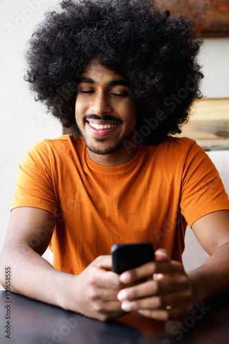 Happy guy looking at cellphone