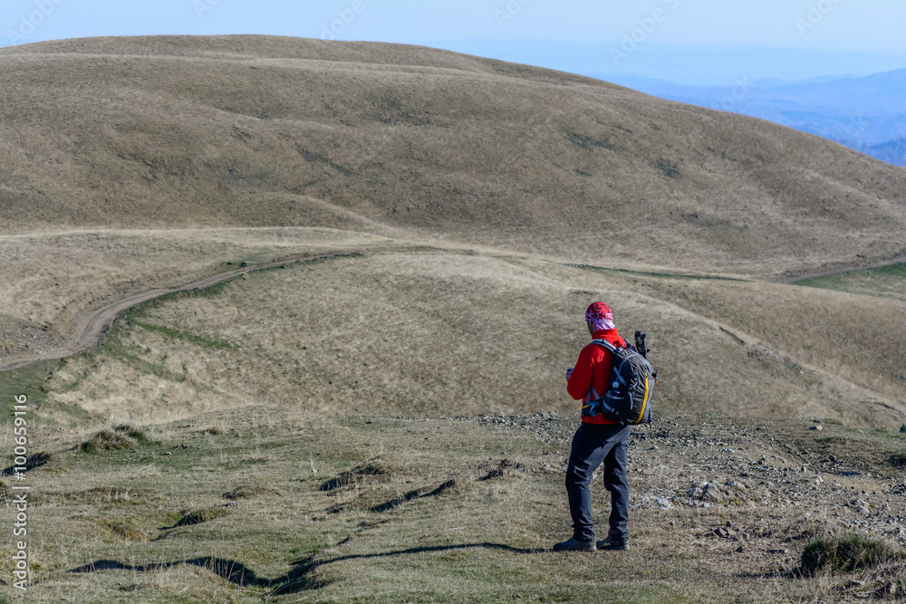 Happy young man standing on mountain.  Happy young tourist man w