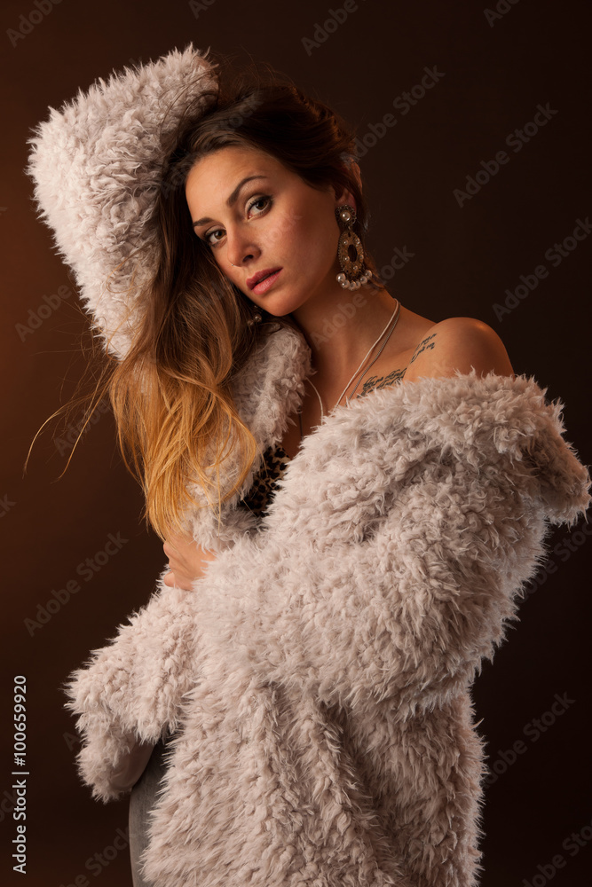 Beautiful young woman with long brown hair posing in studio Beautiful young woman with long brown hair posing in studio