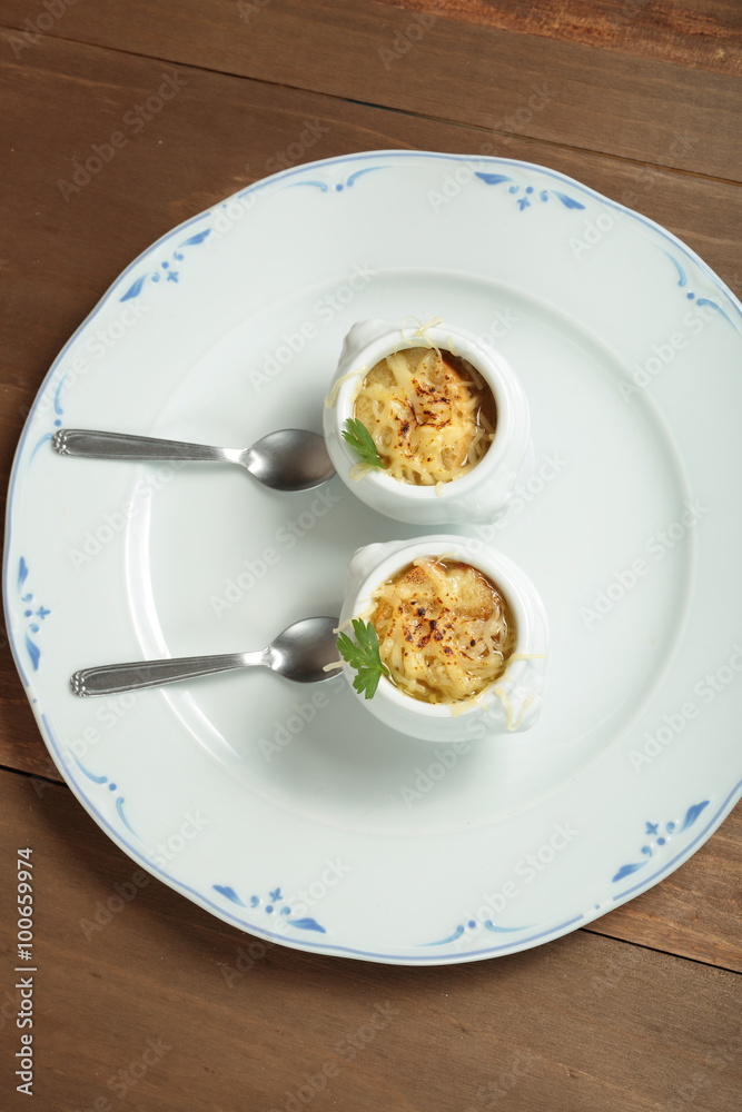 Onion soup served in porcelain bowls
