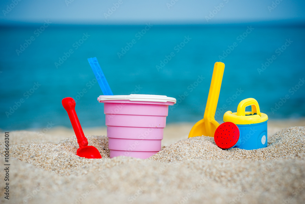 Beach toys , Children's beach toys - buckets, spade and shovel on sand on a sunny day Beach toys , Children's beach toys - buckets, spade and shovel on sand on a sunny day