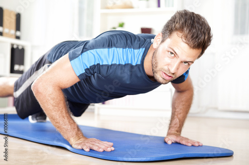 Muscular Man Looking at You While Doing Push ups
