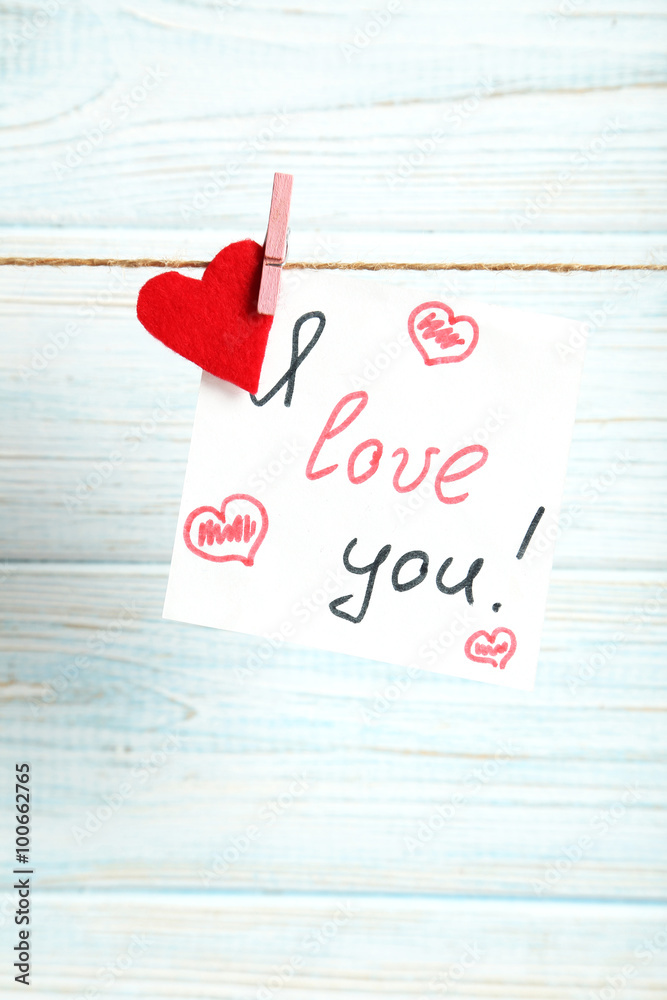 Paper hanging on rope on blue wooden background Paper hanging on rope on blue wooden background