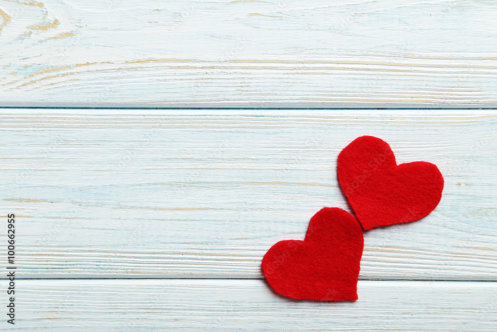 Red hearts on a blue wooden table Red hearts on a blue wooden table