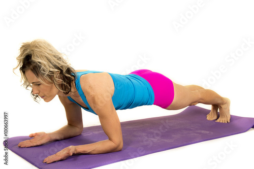 woman blue tank and pink shorts fitness plank on elbows