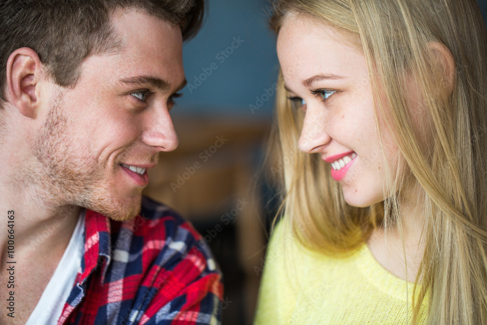 Portrait of a young man and woman looking at each other Portrait of a young man and woman looking at each other
