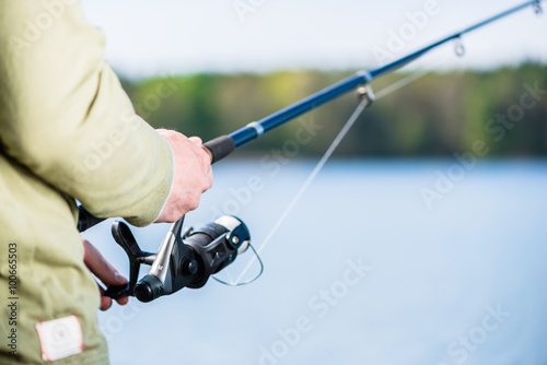 Man fishing with angle at lake