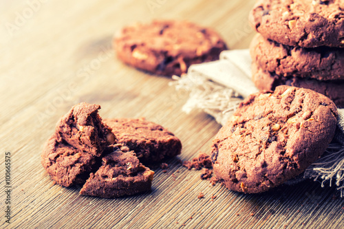 Chocolate biscuit cookies. Chocolate cookies on white linen napkin on wooden table. photo