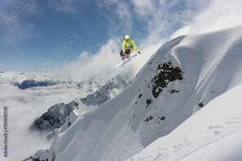 Flying skier on mountains. Extreme sport.